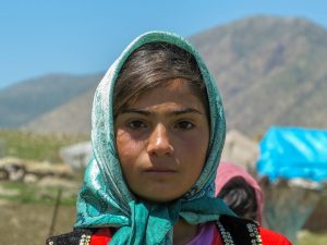 This is a photo of a young Kurdish girl living with her tribe.