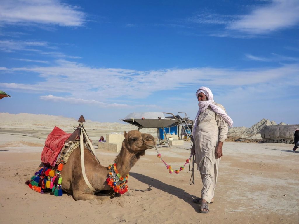 This is a photo of a man and his camel.