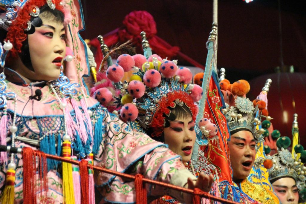 This is a photo of five actors dressed in traditional Sichuan opera cloths.