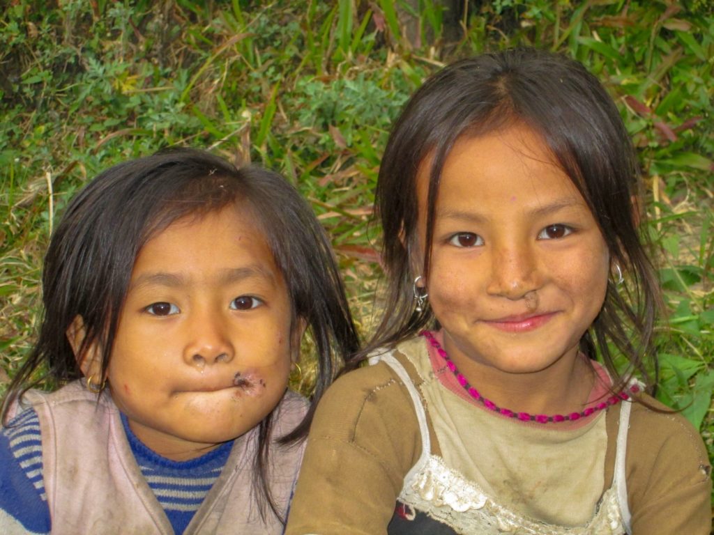 This is a photo of two Kathmandu girls with dirty faces.