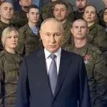 Putin standing in front of Russian troops.