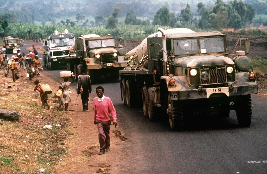 American military vehicles transporting fresh water to Rwandan refugees at Kimbumba camp, Zaire, August 1994.