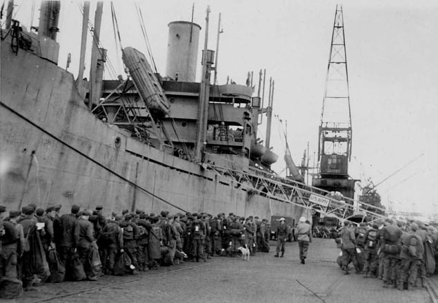 On 19 August 1945, the 1269th Engineer Combat BN docks in Antwerp Harbour, Belgium, ready to board a troopship for their journey home.