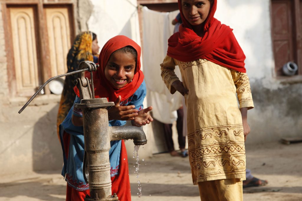 In India, the safety of tap water varies by region. Many areas face challenges with pollution and inadequate treatment, making tap water potentially unsafe. It's advisable to use boiled, filtered, or bottled water, especially for visitors, to avoid health risks. Photo: Children in Sindh, Pakistan, play at a water pump in a village. Credit: UK Department for International Development/ ©  CC BY 2.0 Deed 
