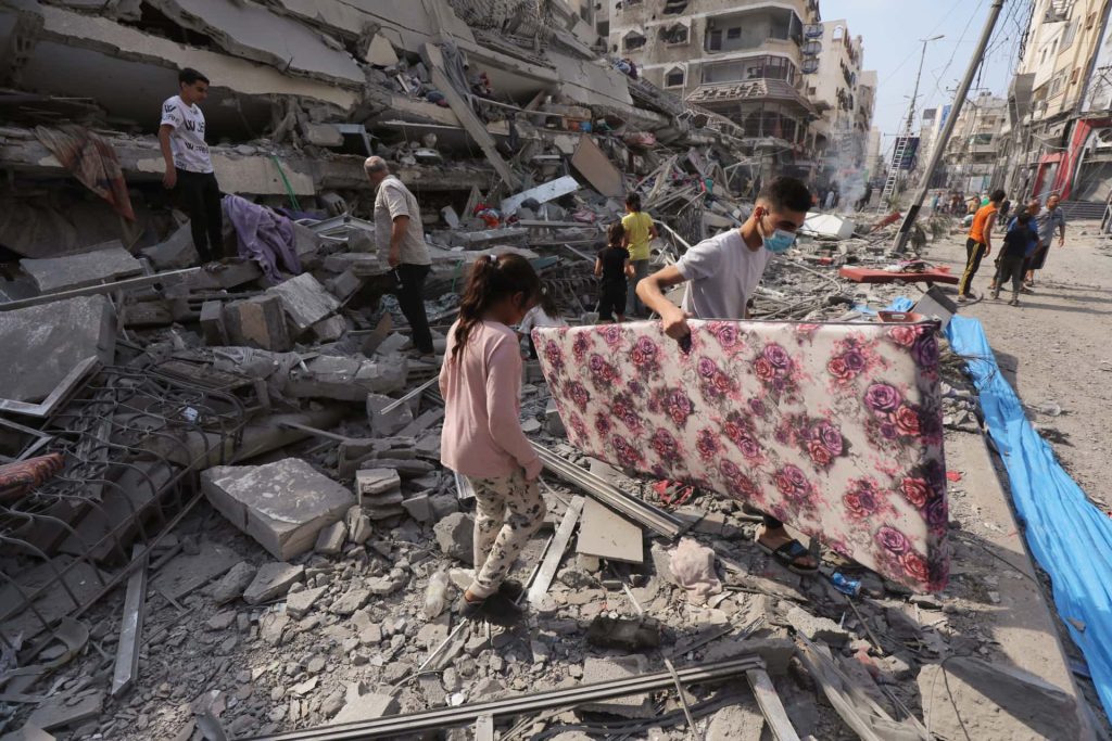 Locals examine the wreckage of a Gaza flat demolished in Israeli air raids.